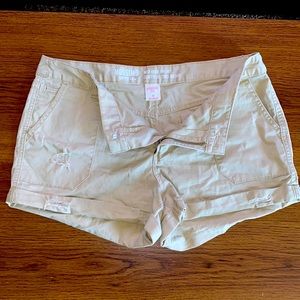 Mid rise tan shorts.